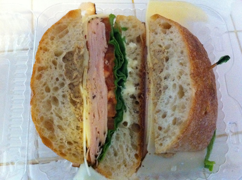 Fresh-sliced honey roasted turkey and baby Swiss on ciabatta with lettuce, tomato, and "Dijon" mustard.