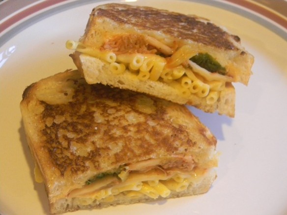 A grilled sandwich of kimchi, mac & cheese and other cheeses.